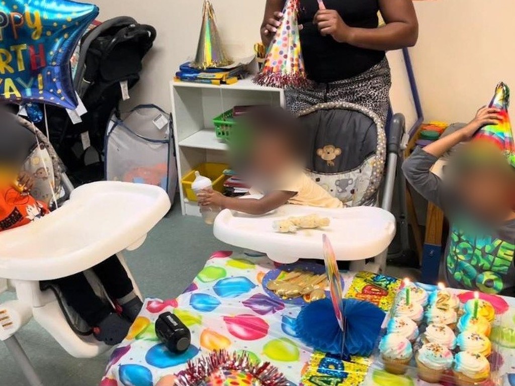 Birthday party table with cupcakes, party hats and a Happy Birthday balloon
