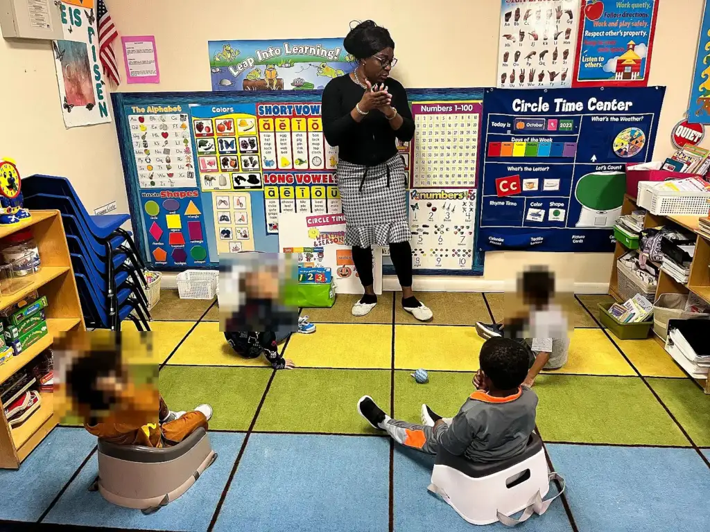 Mrs. McLennon leading circle time at the learning wall